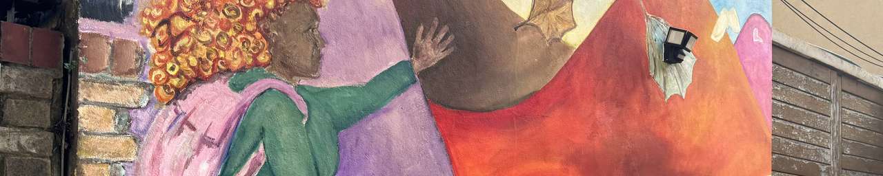 a mural of a woman walking towards colourful mountains