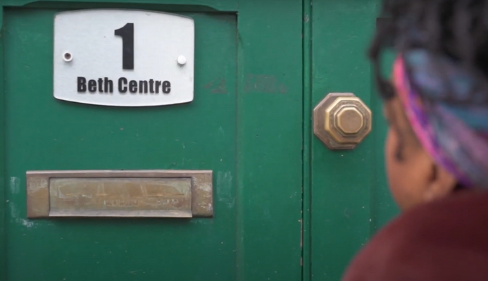 a photo of a woman arriving at a womens centre