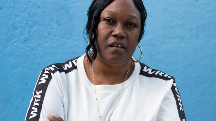 A photo of Jennifer Joseph against a blue wall