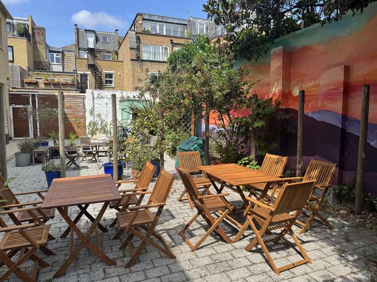a photo of clean break's courtyard garden with tables and chairs set up
