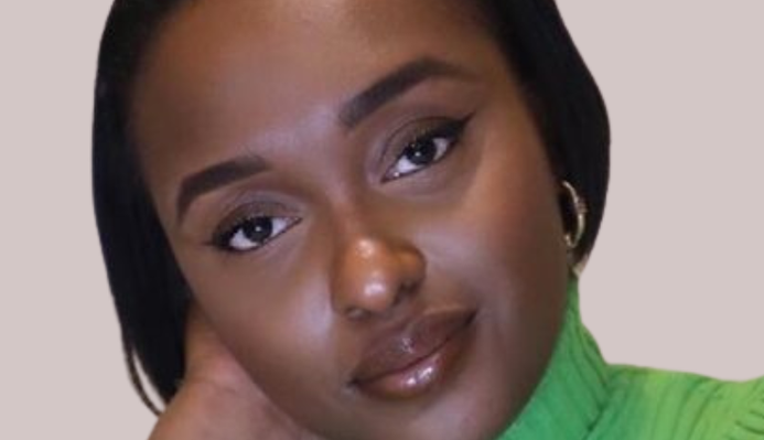 a photo of Yasmin Joseph wearing a green jumper on a beige background