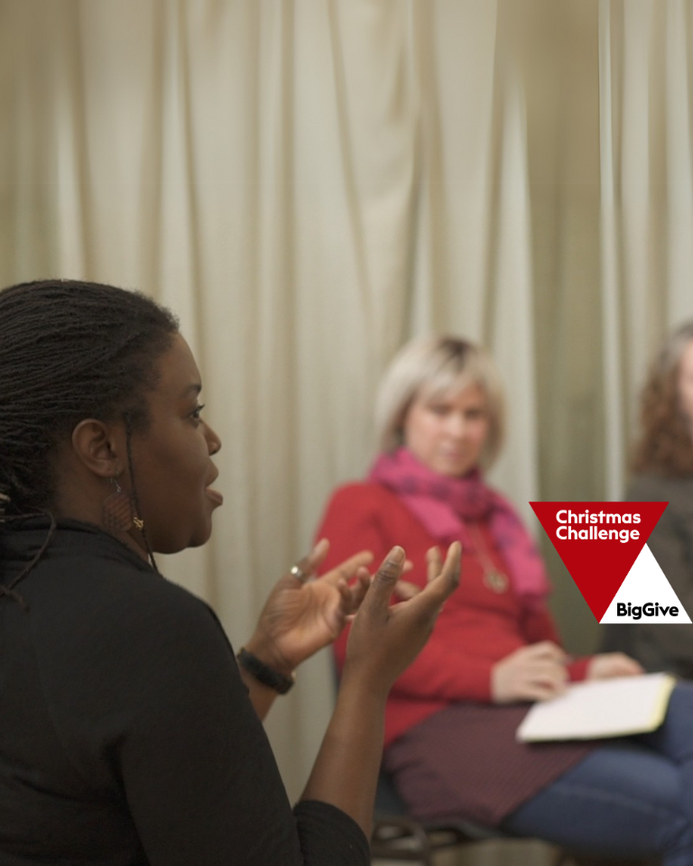 women at a Clean Break workshop sat on chairs in a circle, the Big Give logo in the corner