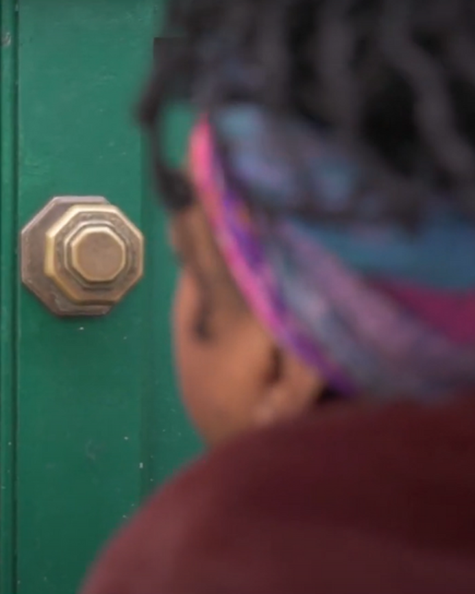 a woman walking up to a women's centre door