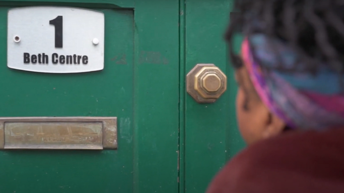 a photo of a woman arriving at a womens centre