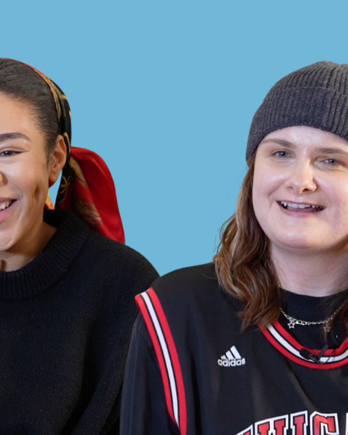 Ro and Shona smiling with a blue background