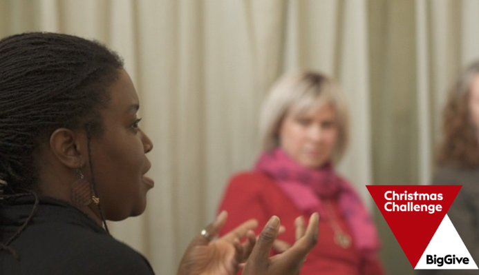 women at a Clean Break workshop sat on chairs in a circle, the Big Give logo in the corner