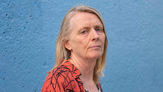 Lucy Edkins in front of a blue wall