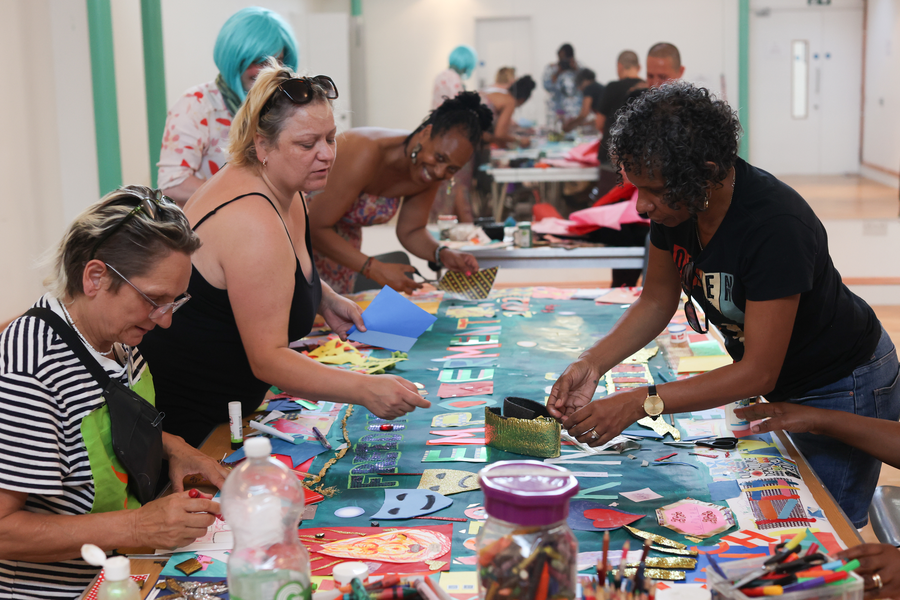 A photo of Clean Break Members working on a collage together